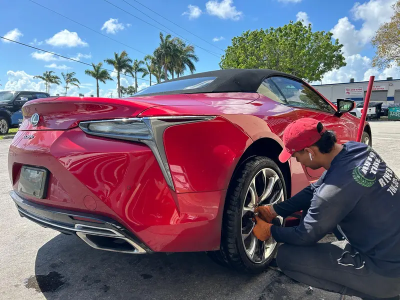 Auto Tire Rivera tech working on a Lexus LC500's rear wheel